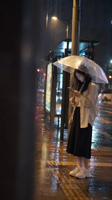 Rainy night bus stop girl