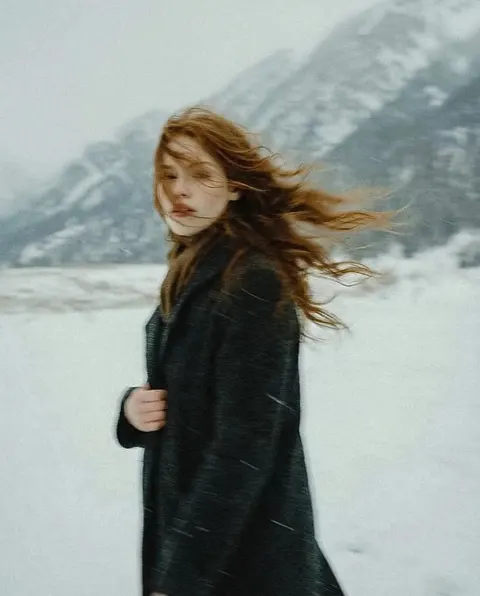 Poetic snowy portrait with windblown hair
