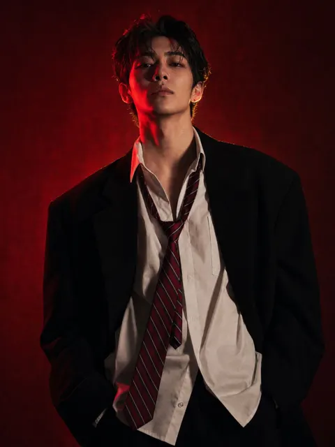 Young east asian fashion red lighting studio portrait