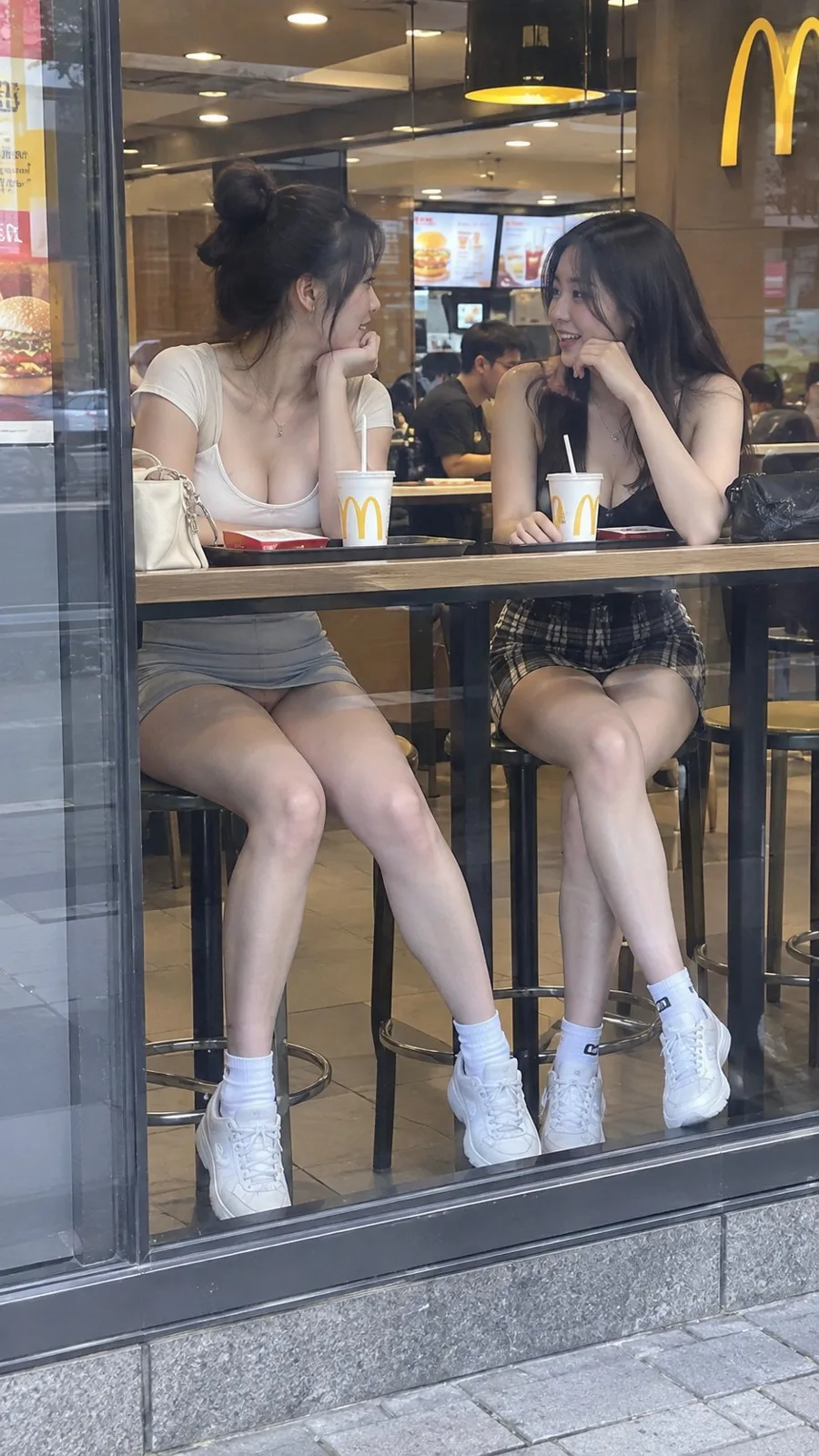 East asian women mcdonalds window chatting — Sonra