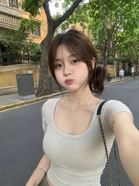 Raw smartphone photo east asian woman city street