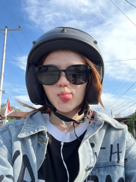 Playful selfie auburn hair motorcycle helmet