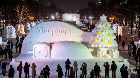 Curled in futon snow sculpture