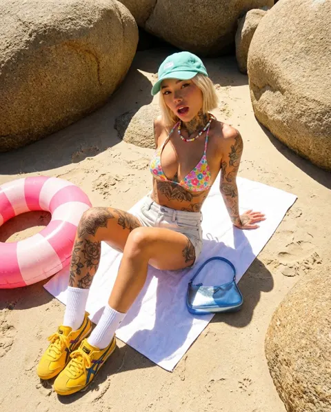 Stylish tattoo girl beach sneakers