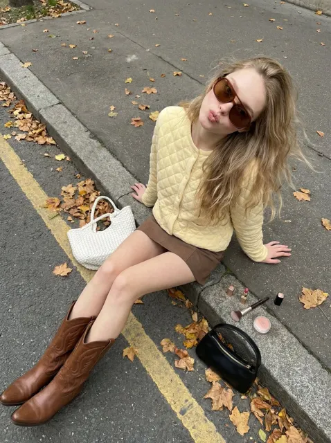 Autumn street playful girl yellow cardigan boots
