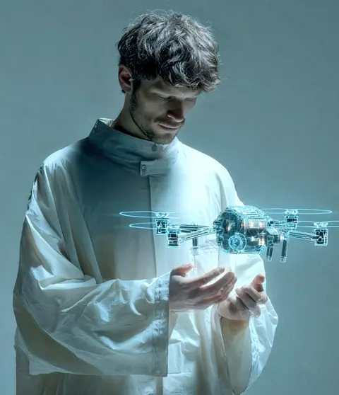 Young man analyzing hologram drone