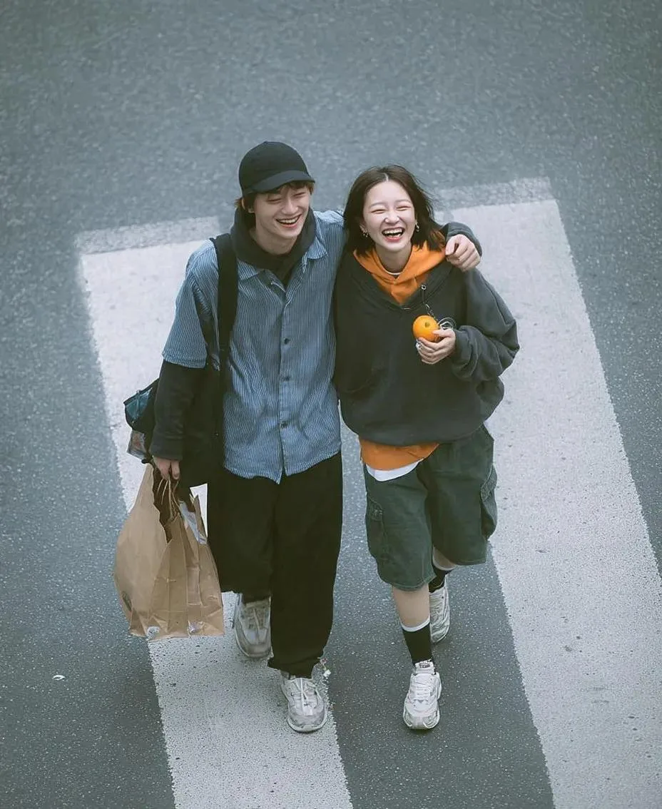 Cinematic overhead street photo young couple zebra crossing — After