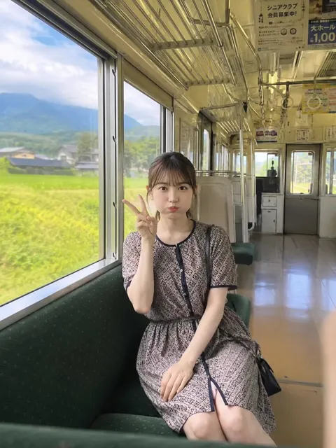 Rural tram puff cheek girl peace sign
