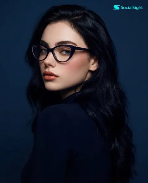 Young woman cat eye glasses studio portrait