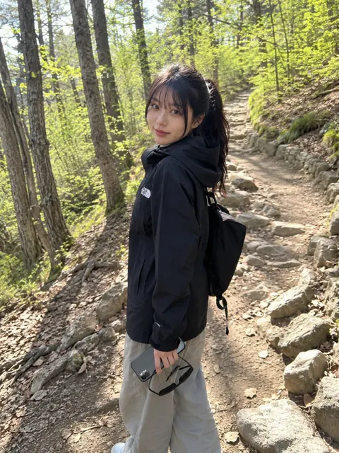 Young japanese woman casual hiking forest trail smartphone photo