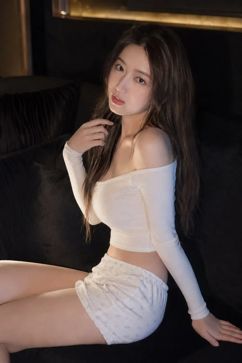 East asian woman dark sofa lazy indoor portrait — After