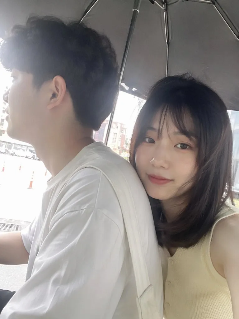 Summer outdoor iphone selfie under umbrella east asian couple — After