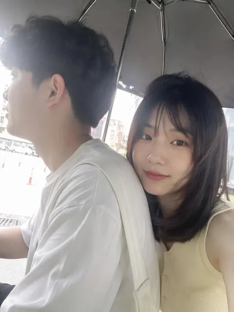 Summer outdoor iphone selfie under umbrella east asian couple