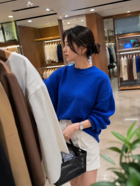 Stylish korean woman cobalt blue sweater fitting room