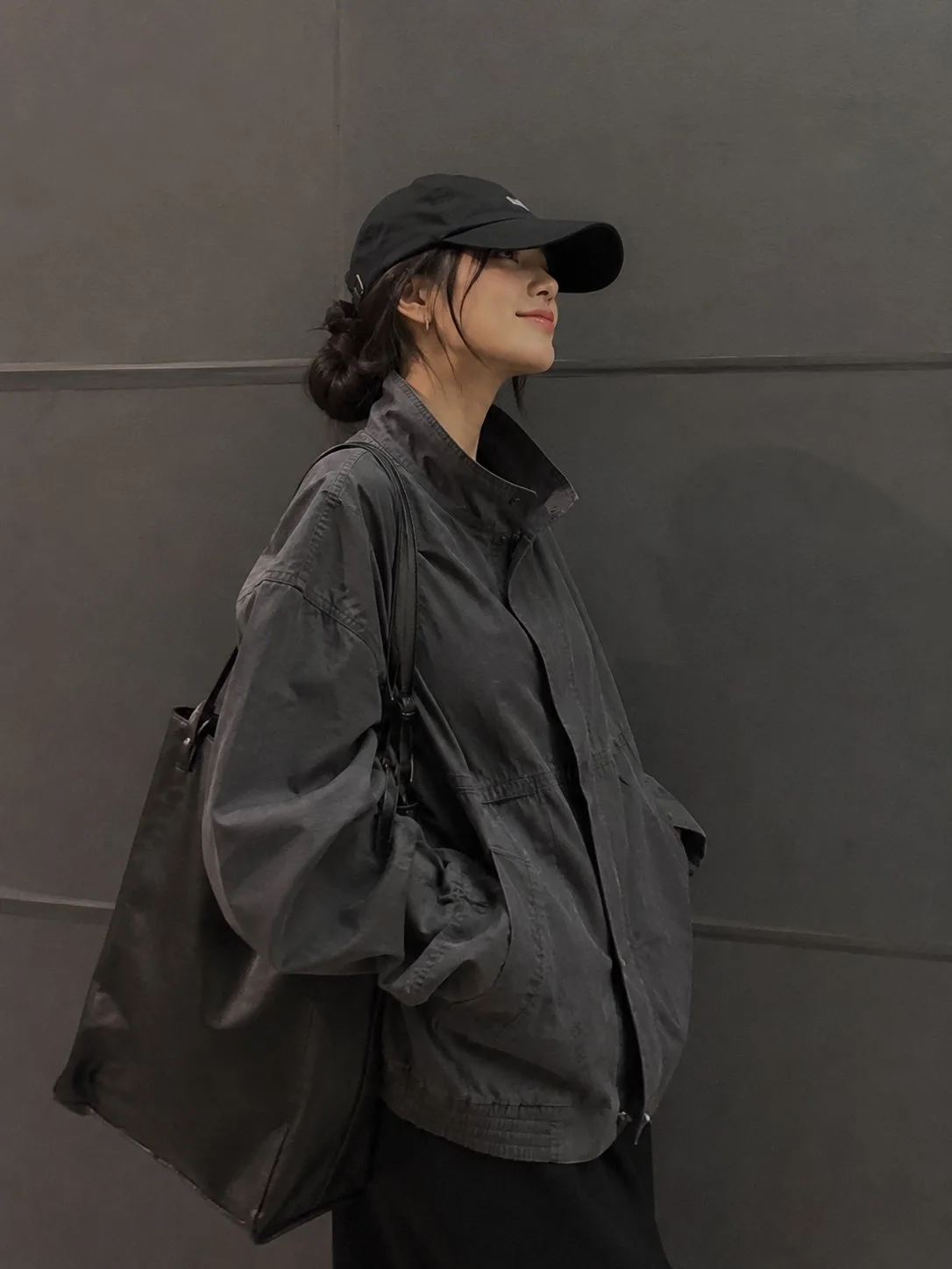 Stylish woman minimalist gray wall streetwear utility jacket — After