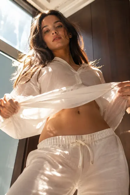 Low angle east european woman white linen shirt editorial