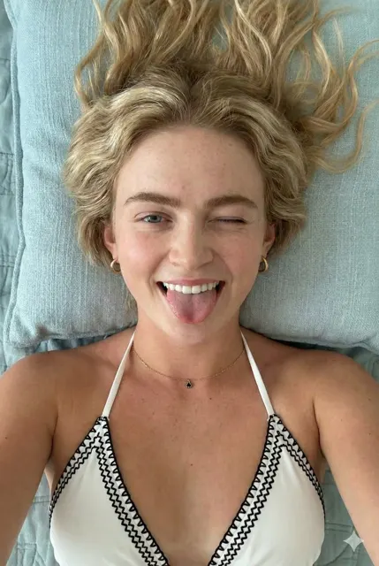Playful freckled blonde winking