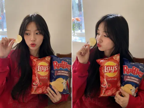 Playful young woman potato chips indoor portrait