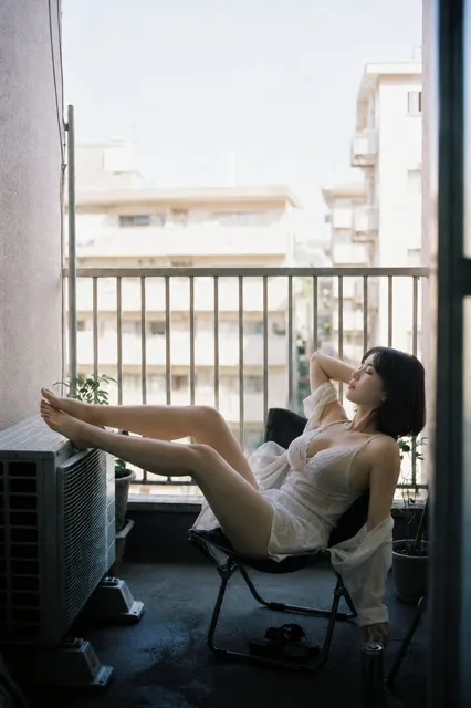 Old apartment balcony rest white dress backlit