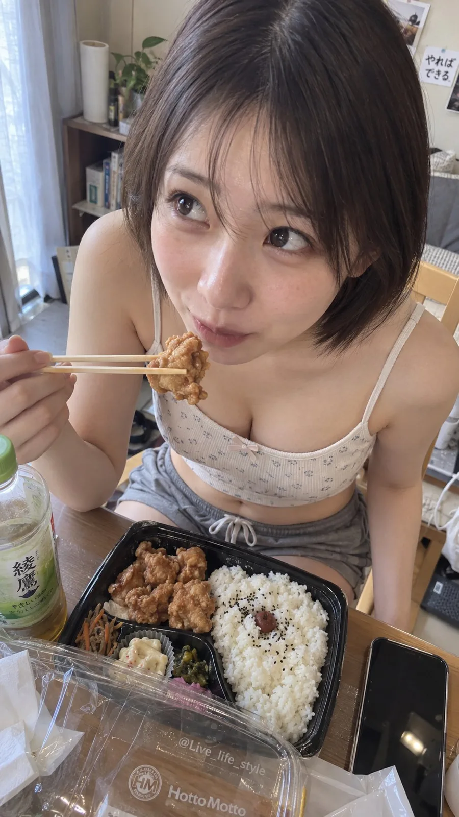 Japanese woman eating fried chicken bento snapshot — After