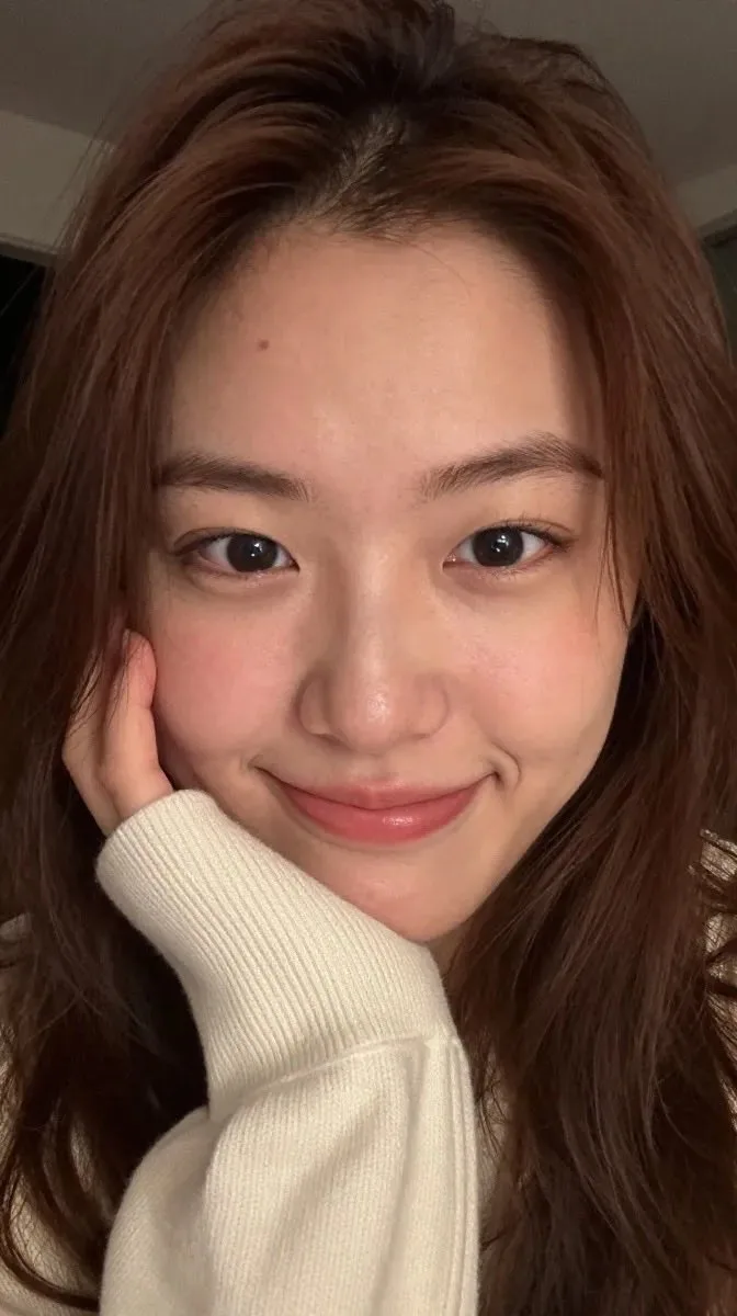 Young east asian woman ribbed turtleneck selfie — After