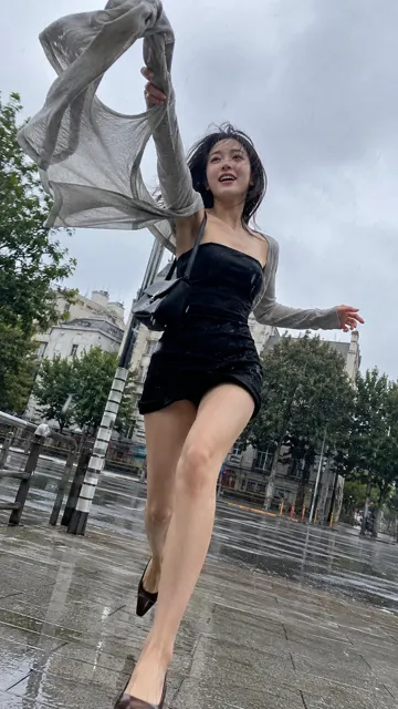 Stylish 20 year old woman rainy street fashion candid