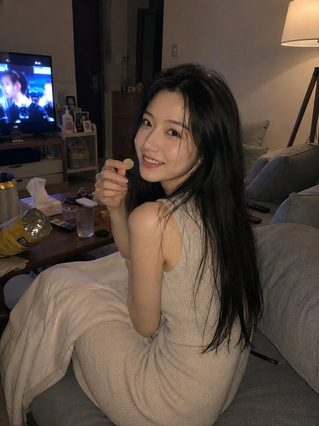 Realistic home candid young asian woman living room — After