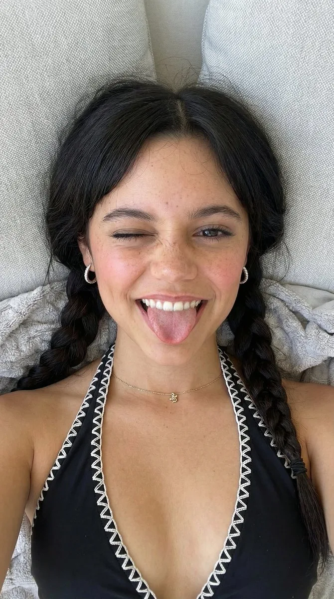 Playful winking girl orange swimsuit — After