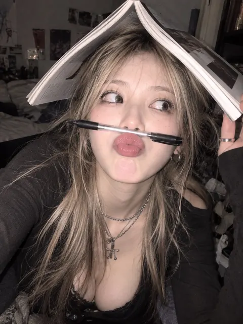 Alt style east asian woman playful bedroom selfie y2k