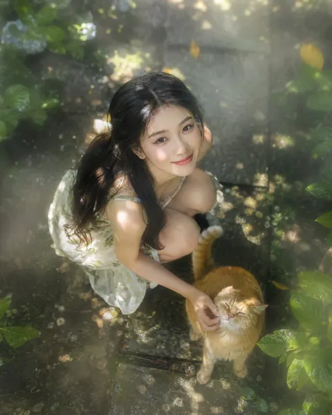 Top down view east asian woman garden cat tyndall effect