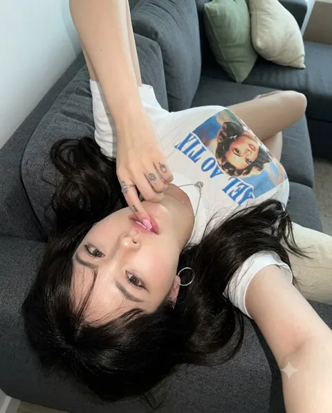 High angle handheld selfie reclining sofa glam