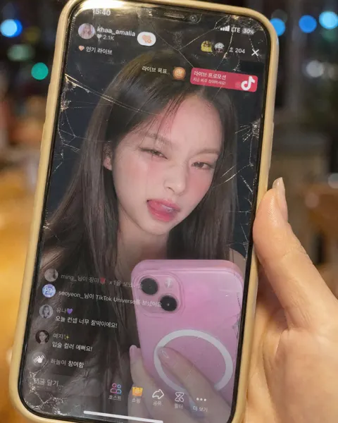 Korean woman holding cracked iphone tiktok live closeup