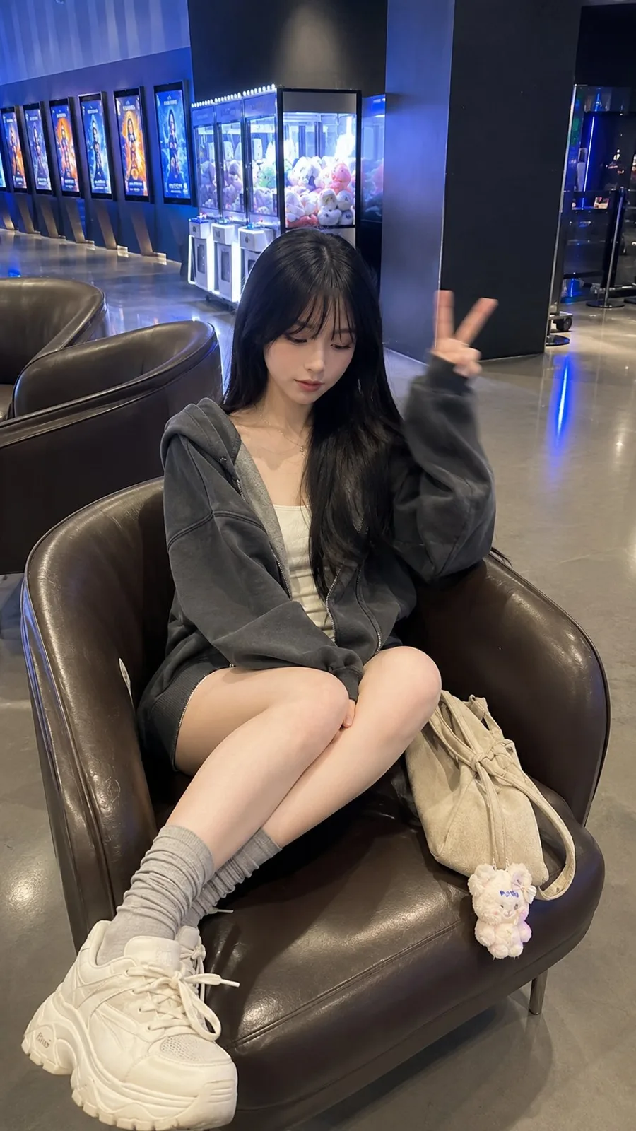 Young east asian woman modern cinema lobby photography — After