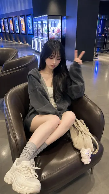 Young east asian woman modern cinema lobby photography