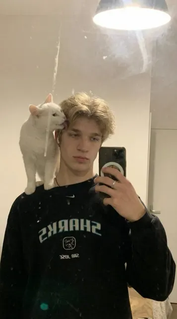 Dim bedroom cat selfie