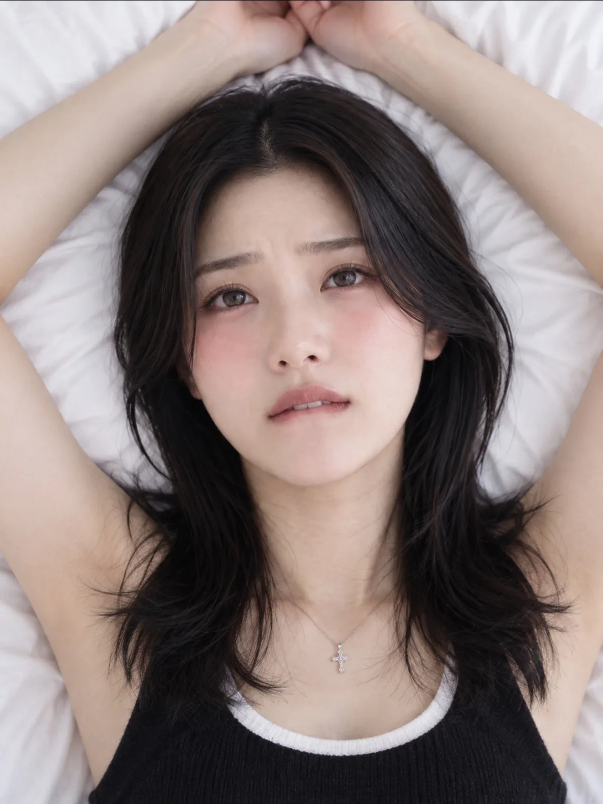 Top down view biting lip hands above head — Sonra
