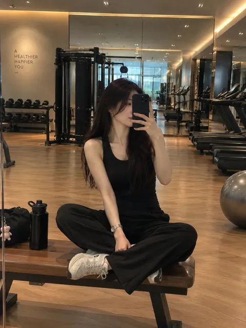 Stylish woman gym mirror selfie luxury interior